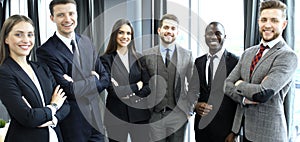 Group of businesspeople standing together in office.