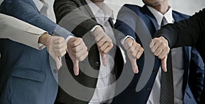 Group businesspeople thumbs down together. concept rejection