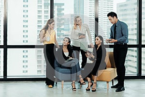 Group of businesspeople using a digital tablet together in office. Business Teamwork partners meeting and brief work.