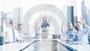 Group of businesspeople waving hands in office