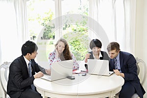Group of businesspeople working on laptop