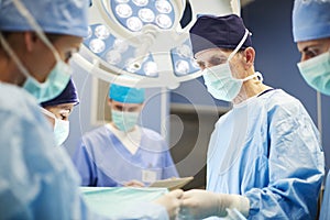 Group of busy doctors in operating room