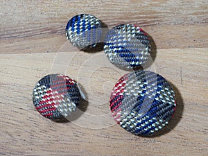 group of button studs on wooden background