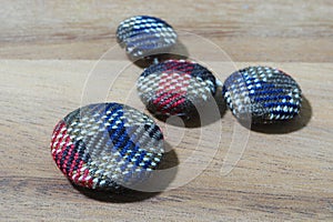 group of button studs on wooden background