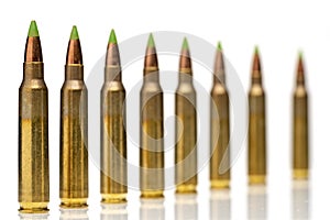 A group of 5.56 calibar, green tip bullets ordered into the line photo
