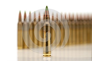 A group of 5.56 calibar, green tip bullets ordered into the line photo