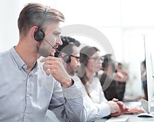 Group of call center employees sitting at the Desk