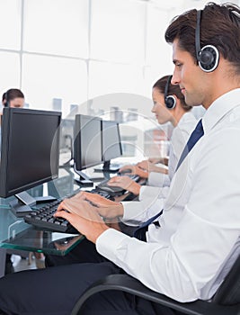 Group of call center employees working on computers