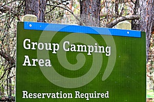 A group camping area sign indicating reservations are required photo