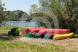 Group of canoes rental kayak on the lake shore beach