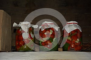 A group of cans with canned tomatoes and cucumbers