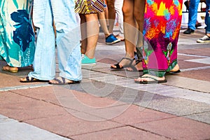 Group of casual men and women standing on paving