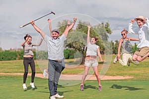 A group celebrating on a golf course