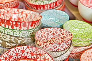 Group of ceramic bowls in the store. Plates with different colorful patterns