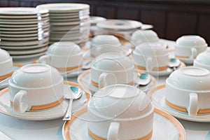 Group of ceramic cup and plates stacked on the table for tea or coffee service