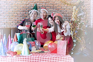 Group of cheerful asian people friends party celebrating Christmas or Happy new year. Cheerful handsome man and young woman