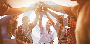 Cheerful business people giving high five while sitting creative office