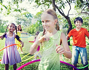 Group Cheerful Children Playing Hulahoop Concept