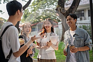 Group of cheerful diverse Asian college students are enjoying talking after classes together