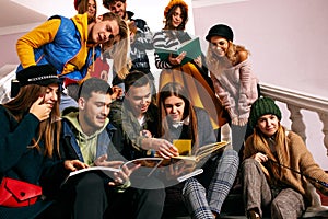 The group of cheerful happy students sitting in a lecture hall before lesson