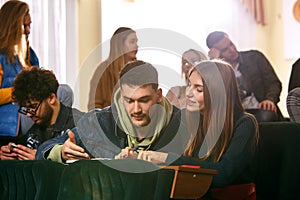 The group of cheerful happy students sitting in a lecture hall before lesson