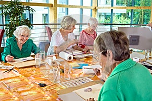 Group of cheerful older students painting together