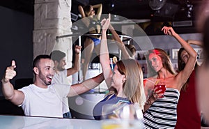 Group of cheerful people clubbing in the club
