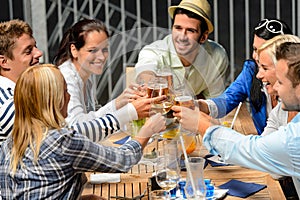 Group of cheerful people toasting with drinks