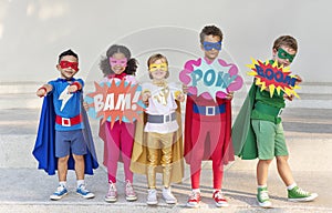 Group of cheerful superheroes kids together