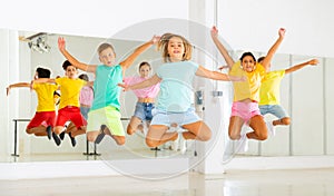 Group of cheerful tweens jumping during dances class