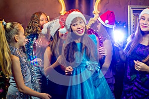 Group of cheerful young girls celebrating Christmas