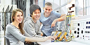 group of cheerful young students in vocational education and training for electronics photo