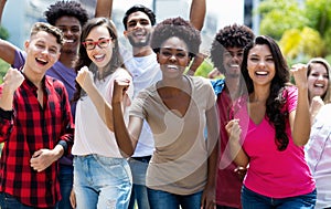 Group of cheering african american and caucasian and hispanic and latin young adults