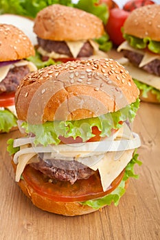 Group of cheeseburgers, with ingredients