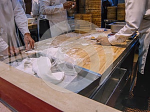 A group of chefs making dumplings in the restaurant