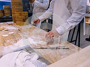 A group of chefs making dumplings in the restaurant