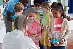 Group Of Children Carrying Out Experiment In Science Class