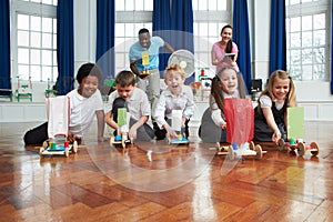 Group Of Children Carrying Out Experiment In Science Class