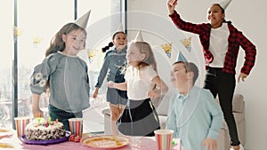 Group of children celebrating birthday party at decorated home