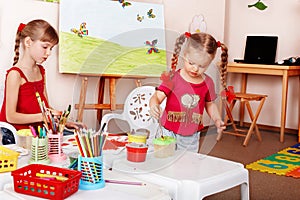 Group of children with colour pencil.