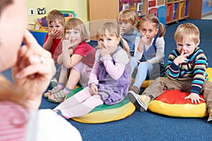Group Of Children Copying Teacher In Montessori/Pre-School Class photo