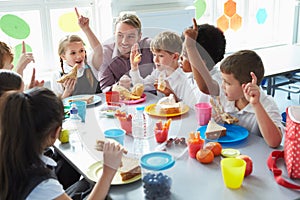 Group Of Children Eating Lunch In School Cafeteria