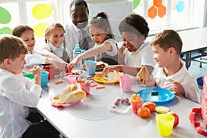 Group Of Children Eating Lunch In School Cafeteria photo