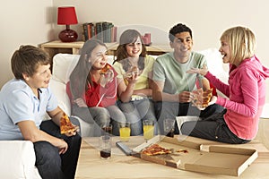 Group Of Children Eating Pizza At Home