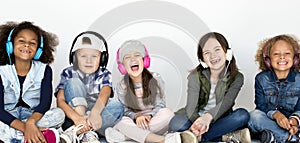 Group of children enjoy the music by headphones