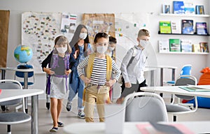 Group of children with face mask back at school after covid-19 quarantine and lockdown.