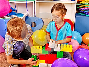 Group children game blocks on floor .