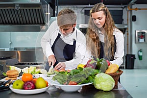 Group children girl and boy leaning and cut vegetables for cooking food.