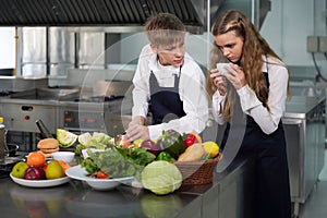 Group children girl and boy leaning and cut vegetables for cooking food. Chef teacher teaches cooking