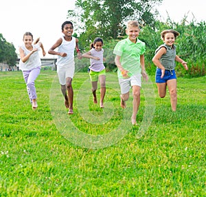 Group of children having fun together outdoors running